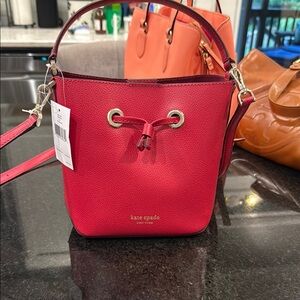 Kate Spade Red Crossbody Bag with Drawstring Closure with matching wallet
NWT